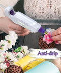 Person using full size dual temp hot glue gun with 60 and 100 watt power on off switch for craft DIY with flowers, anti-drip feature visible