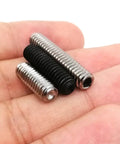 Close-up of 10 Pack UNC 1/4-20 Set Screws, 304 Stainless Steel Black Oxide Hex Socket Cup Point Grub Bolts in hand.