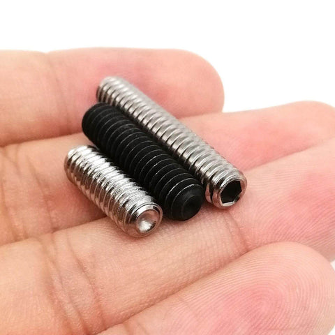 Close-up of 10 Pack UNC 1/4-20 Set Screws, 304 Stainless Steel Black Oxide Hex Socket Cup Point Grub Bolts in hand.