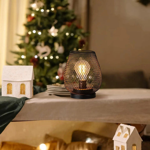 Set Of 4 Battery Operated LED Table Lanterns In Rustic Brown Metal Cage on festive table near Christmas tree