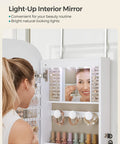 Person using LED Jewelry Cabinet Organizer With Lockable Door And Wall Mount Rounded Wide Mirror Hidden Jewelry Storage Interior Mirror 3.9 x 16.5 x 42.5 Inches White Surface With Greige Lining Dope Modern Sleek Design in bathroom.