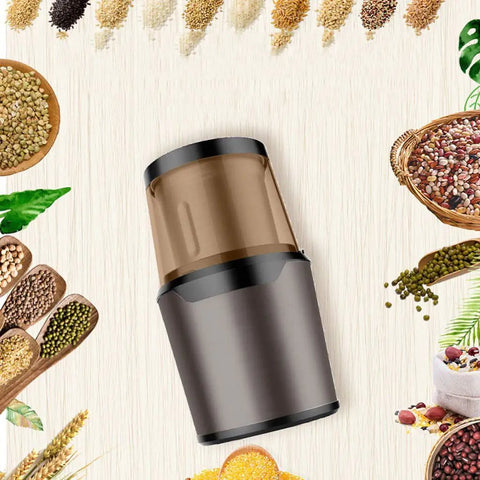 No Brainer Portable Bean To Cup Coffee Grinder And Spice Mill With Tap Control Quick Crushing Action Stainless Steel Bin viewed from above surrounded by spices.