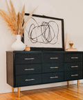 Black dresser with Ultra Cool 3 Inch Crystal Clear Acrylic Drawer Pulls with Sleek Gold Accents 20 Pack Set installed.