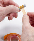 Hands applying VC-3 Threadmate Red Threadlocker And Tape Kit to fastener, preventing loosening, for internal external threads, 5mL tube.