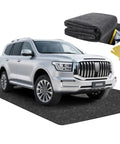 Heavy Duty Garage Floor Mat With Adhesive Backing For Under Car Work Area Oil And Water Resistant Grippy Non Slip Protector Absorbent Fabric With Waterproof Backing Garage Rugs And Mats To Guard Floors From Spills underneath SUV with folded mat and adhesive tapes