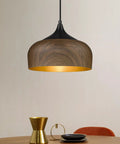 Modern Walnut Wood Dome Pendant Light Matte Black Metal With Warm Gold Interior Adjustable Hanging Fixture over dining table.