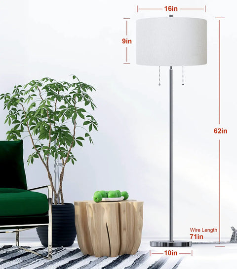 Modern Two Light Floor Lamp With Dual Pull Chains Tall Standing Light In Brushed Nickel Finish And White Lampshade Accepts Two E26 Bulbs Up To 60W Each Or One 100W Perfect For Living Room Bedroom Or Office next to green chair and wooden table.
