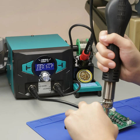 Using Pro Grade 2 In 1 Soldering Iron Station With Hot Air Rework And Sleep Mode for precise electronics repair on circuit board.