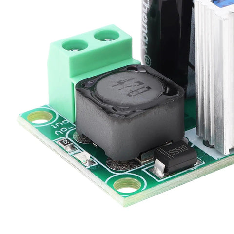 Close-up of High Voltage DC To DC Buck Converter Module LM2596HV 50V Max Input Adjustable Step Down Regulator on green circuit board.