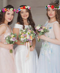 Three women wearing DIY Flower Crown Making Kit With 168 Pieces For Creating Floral Wreath Headbands And Bracelets Craft Set.