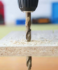 GMTOOLS 1/8 inch cobalt twist drill bit drilling into wood with wood shavings and chuck visible