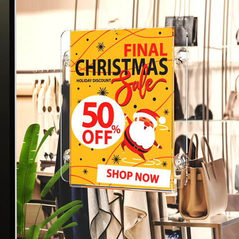 Clear Acrylic Window Sign Holder With Suction Cup 8.5 X 11 Inches displaying Christmas sale sign in a clothing store.