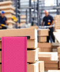 Hot Pink 8.5 X 12 Inch Bubble Mailers Dope Self Seal Padded Envelopes in warehouse with stacked boxes and workers