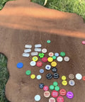 No Brainer Walnut Aging Wood Stain In 5 Gallon Pails on a rough cut lumber surface with various colorful tokens.