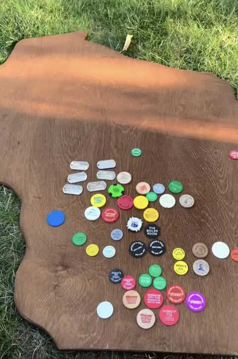 No Brainer Walnut Aging Wood Stain In 5 Gallon Pails on a rough cut lumber surface with various colorful tokens.