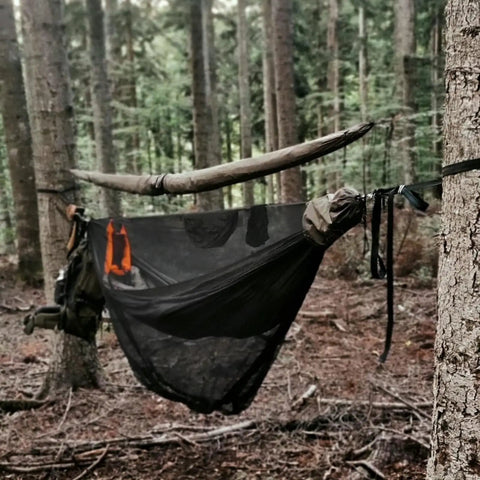 Double Camping Hammock With Mosquito Net Ridgeline And Straps 11Ft Lightweight Nylon Ripstop 500lb Capacity set up in a forest.