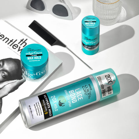 Lace Bond Adhesive Spray with Ultimate Hold for Lace Frontals, sweat proof, water resistant, lying next to comb on table.