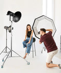 Photographer setting up in studio with professional light stand wheels set 0.9 inch 22mm diameter swivel casters for photography stands