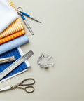 Badass Durable 110 Pack Leathercraft Screw Rivets And Gnarly Heavy Duty Metal Fasteners For Wallet Stitching And Journal Repairs Featuring A Hella Neat Sortable Case To Keep Your Crafting Session Tight with assorted fabrics and scissors.