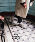 Person walking on hexagonal tiled path with Hexagonal Concrete Molds For Pavers And Stepping Stones Reusable Flexible Walkway Molds