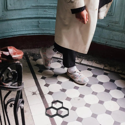 Person walking on hexagonal tiled path with Hexagonal Concrete Molds For Pavers And Stepping Stones Reusable Flexible Walkway Molds