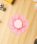 120pc Fire Sprinkler Dust Guards That Keep Grit Out Of Your Gear Heavy Duty Elastic Caps on a wooden surface, showing pink guard design.