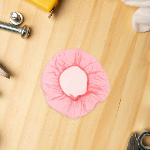120pc Fire Sprinkler Dust Guards That Keep Grit Out Of Your Gear Heavy Duty Elastic Caps on a wooden surface, showing pink guard design.