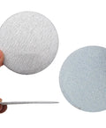 High Grade 100 Pcs 4 Inch Hook And Loop White Sandpaper For Dry Grinding And Polishing With Cool Dust Venting Holes and Peel-And-Switch Backing to Swap Fast No Tools Needed, showing the textured surface.