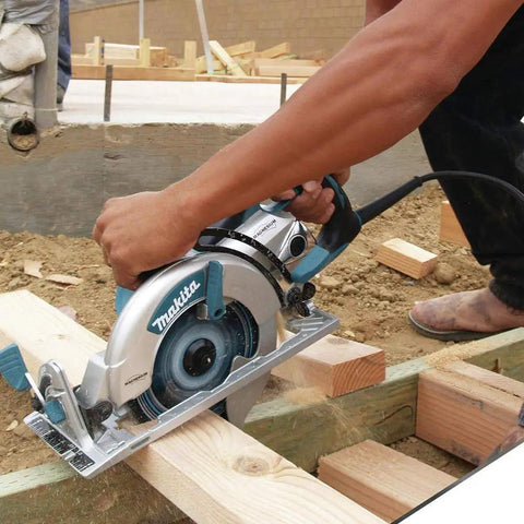 Person using Lightweight Magnesium Hypoid Saw With Seven And One Quarter Inch Blade, 13.2 Lb Job Site Tough Power Tool for cutting wood.