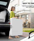 Woman carrying Six Foot Folding Table For Indoor Outdoor Use, Portable Long Rectangular Table With Carrying Handle, folded state