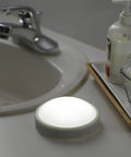 Luna LED Tap Light White Battery Operated Tap On Tap Off 35 Lumens next to sink, ideal for dark corners and power outages.