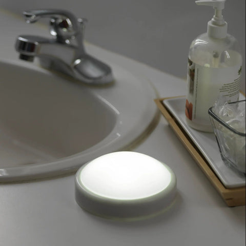 Luna LED Tap Light White Battery Operated Tap On Tap Off 35 Lumens next to sink, ideal for dark corners and power outages.