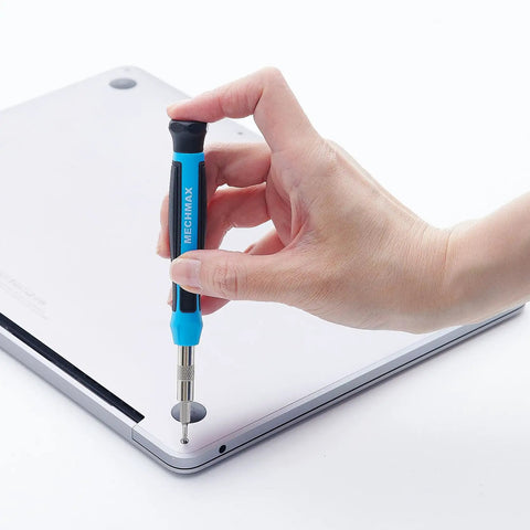 Hand using Pro Grade All In One Magnetic Precision Screwdriver Set With 51 Pieces for Electronics Repair on laptop back panel.