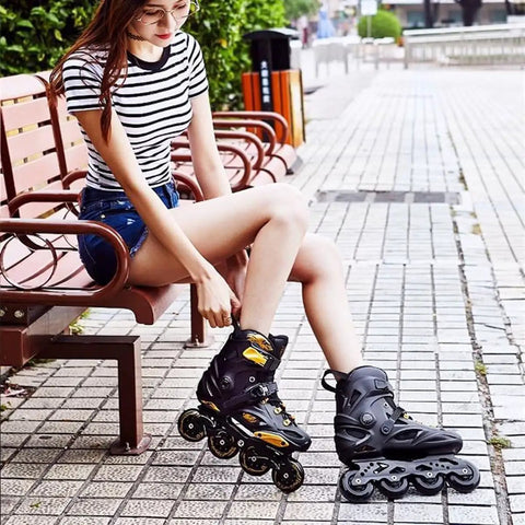 Woman wearing Men Inline Skates With Light Up Four Wheels, sitting on a bench, showcasing adjustable roller blades for outdoor fitness.
