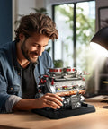 Man building Badass Tiger Tank Engine Building Blocks Set 1236 Pieces Heavy Duty Military Mechanical Gear Model Kit on table