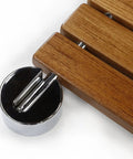 Close-up of Heavy Duty 20 Inch Teak Wood Folding Shower Seat wall mount with chrome hardware, showing teak slats and stainless steel frame.