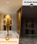 HITOO 3 Inch Motion Sensor Recessed Downlight Light 3000K, White, 2 Pack illuminating a hallway with a woman walking.