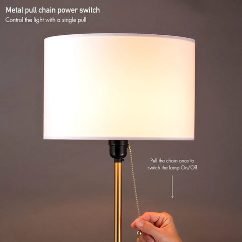 Hand operating pull chain on Drum Shade Standing Lamp with Pull Chain Switch, E26 Socket, Dope Modern Minimalist Floor Lamp In Antique Brass