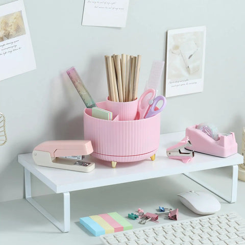 Pink Desk Accessories Set With Rotating Pen Holder, Stapler, Staple Remover, Tape Dispenser And Refills on a white shelf.