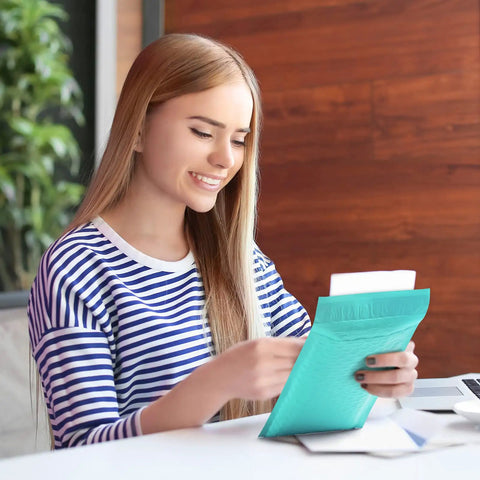 Woman smiling holding Teal Bubble Mailers 6x10 Inch Inner 6x9 Inch 25 Pack Padded Envelopes With Self Seal Waterproof Opaque Shipping Bags