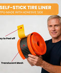 Man holding Two Pack Bike Tire Liners With Self Adhesive Puncture Proof TPU Tube Protectors 40mm Thick, showing peel-off adhesive.