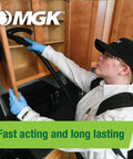 Technician using pest control equipment under kitchen cabinets, emphasizing fast acting and long lasting results.
