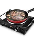 Portable 1500W Electric Hot Plate Stove with adjustable temperature and stay cool handles cooking steak in a pan