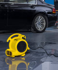 Professional 500 Max CFM Air Mover With 12 Ft Cord, 3 Drying Settings in operation on wet garage floor
