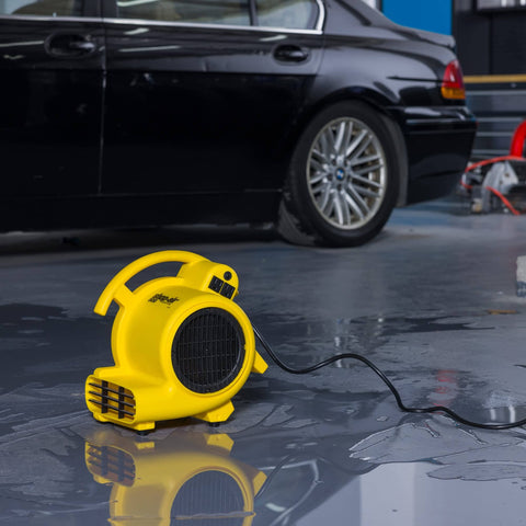 Professional 500 Max CFM Air Mover With 12 Ft Cord, 3 Drying Settings in operation on wet garage floor