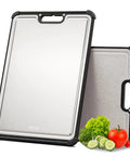 Front view of dual‑sided cutting board with stainless steel surface in a black frame; extra‑large 16.9 in x 11.8 in