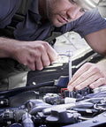 Close-up of mechanic using a 1/4–1/2 in drive converter sleeve set (alloy) on a car engine