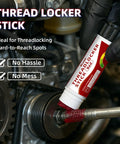 Applying red high strength threadlocker stick to a bolt for secure, vibration-resistant locking in machinery repair.