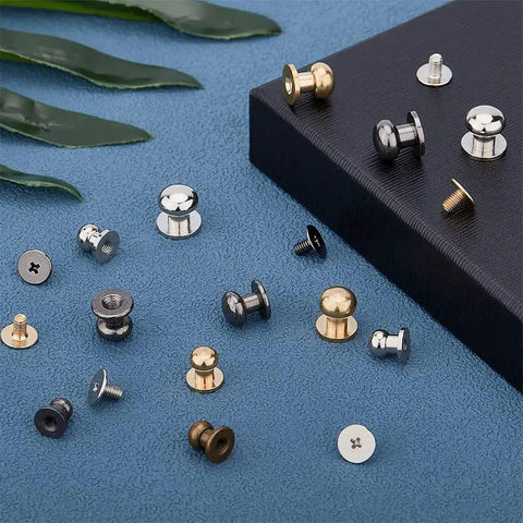 Pro-Level Gear 64 Set Metal Button Studs With Screwback Design In 4 Sick Colors Including Antique Bronze Gunmetal Platinum And Gold For Serious Diy Projects Jewelry Making Leather Work Heavy Duty Steel Hardware That Hits Different, assorted studs on blue surface.