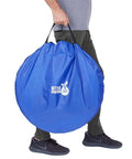 Person holding blue carry bag for 10 Foot Dog Agility Tunnel With Two Sandbags One At Each End For Backyard Training.